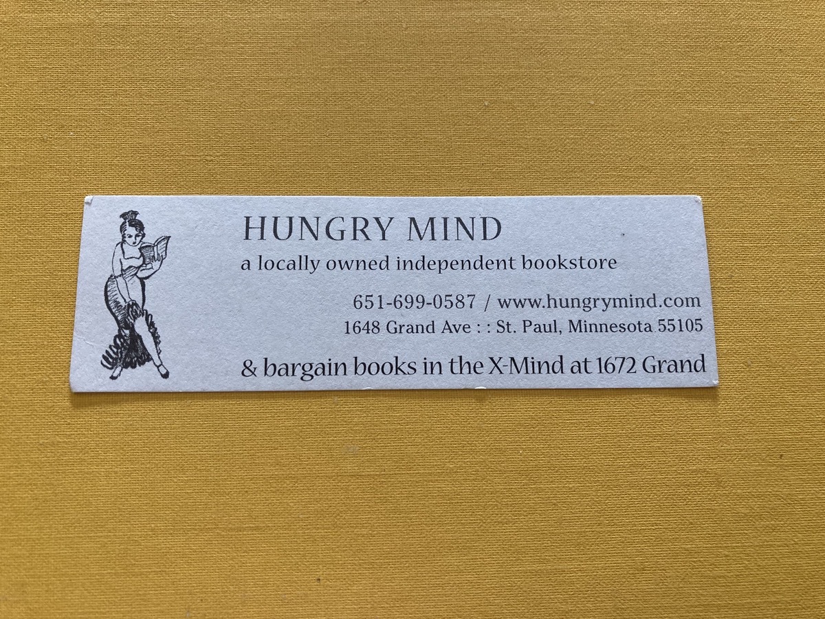 small bookmark from Hungry Mind showing a small señora lifting her long frilled skirt and holding a fan which is an opened book