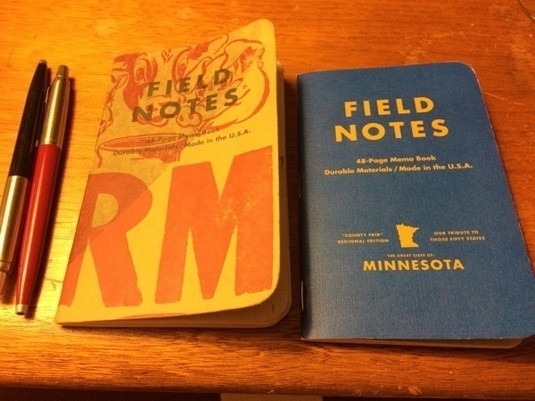 Field Notes Two Rivers and MN County Fair Blue Ribbon with two Parker Jotters nearby